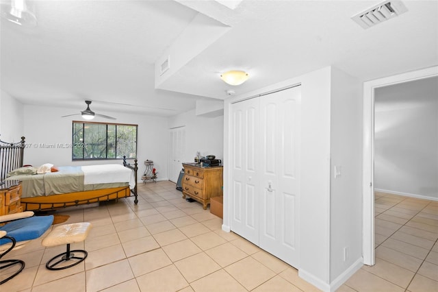 tiled bedroom with ceiling fan