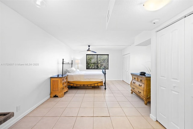 tiled bedroom featuring ceiling fan