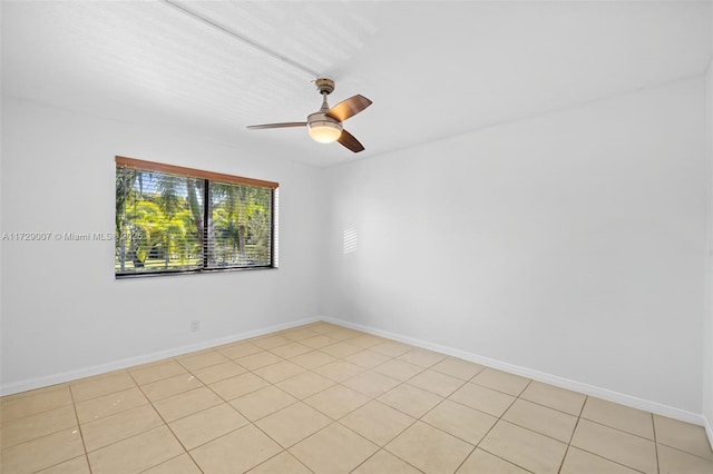 tiled empty room featuring ceiling fan