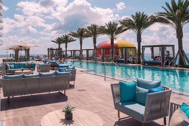 view of pool with an outdoor living space and a patio