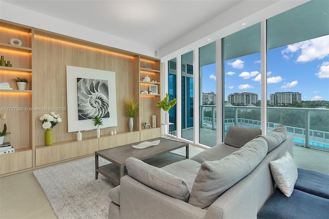 living room featuring a healthy amount of sunlight, built in features, and expansive windows