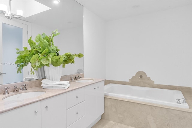 bathroom with vanity, tile patterned floors, and a relaxing tiled tub