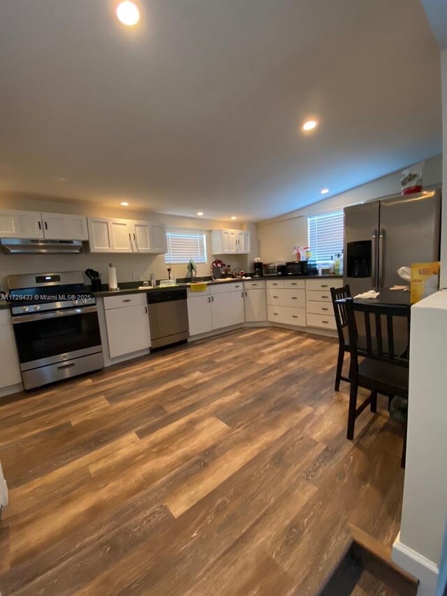 kitchen featuring hardwood / wood-style floors, plenty of natural light, white cabinets, and appliances with stainless steel finishes