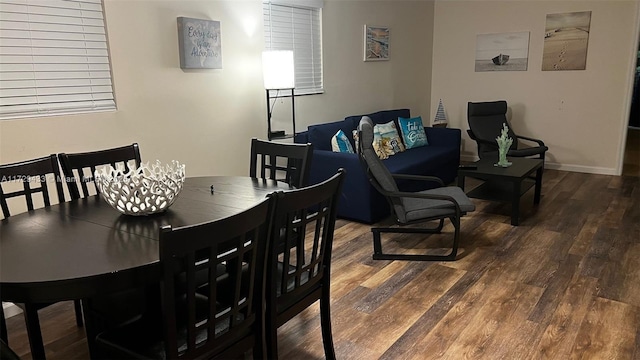 dining area featuring dark wood-type flooring