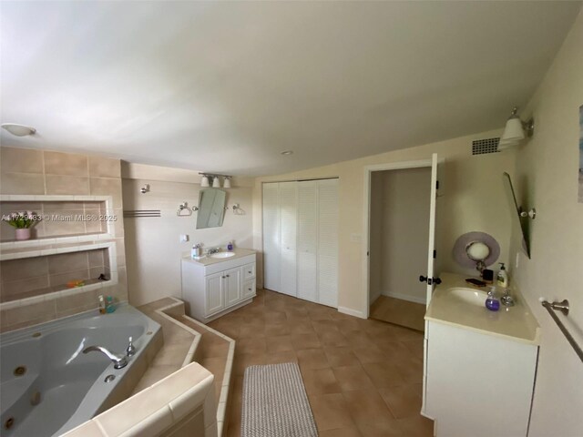 bathroom featuring vanity and a bath