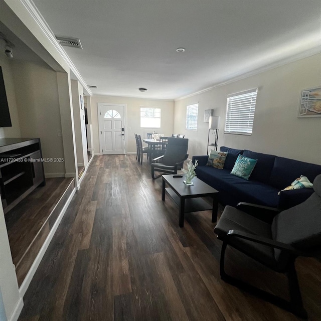 living room featuring ornamental molding and dark wood-type flooring