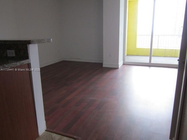 unfurnished room featuring dark hardwood / wood-style floors