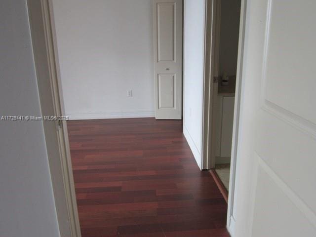 hall with dark wood-type flooring