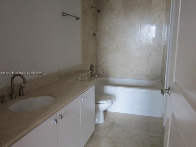 full bathroom featuring toilet, tiled shower / bath, and vanity