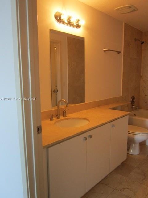 full bathroom featuring toilet, vanity, and tiled shower / bath combo