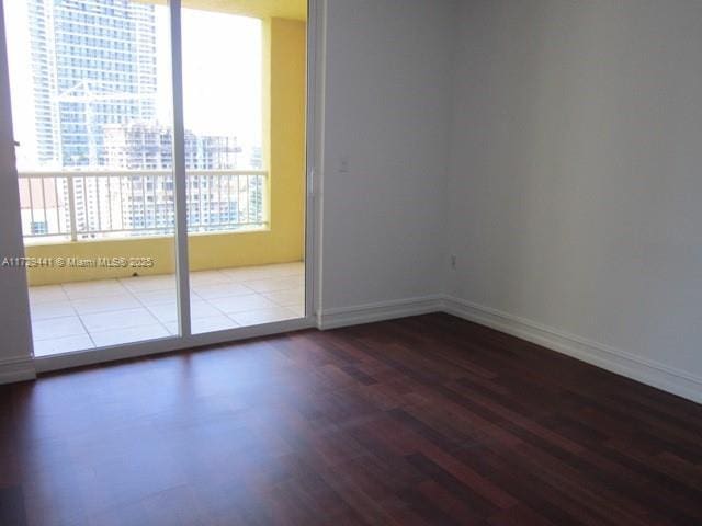 empty room with hardwood / wood-style flooring