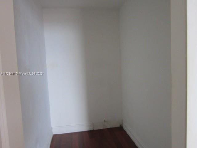 unfurnished room with dark hardwood / wood-style flooring