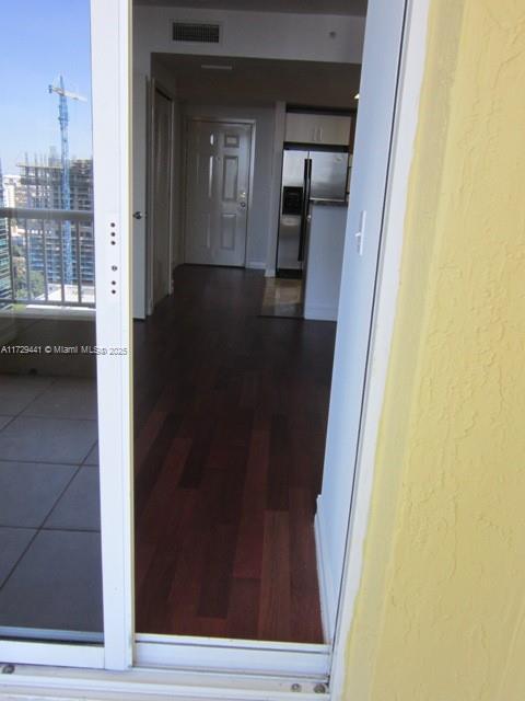 corridor featuring dark hardwood / wood-style flooring