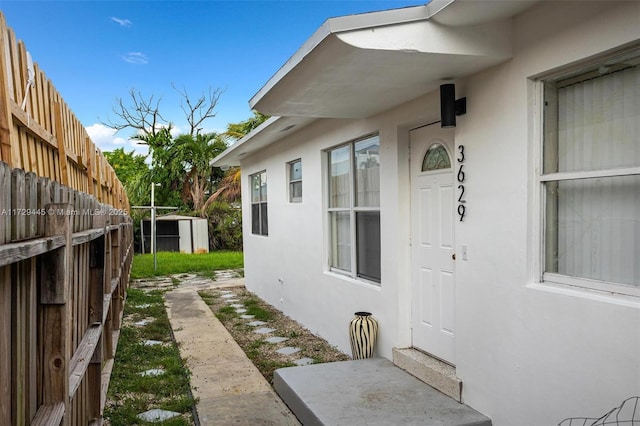 view of side of home with a storage unit