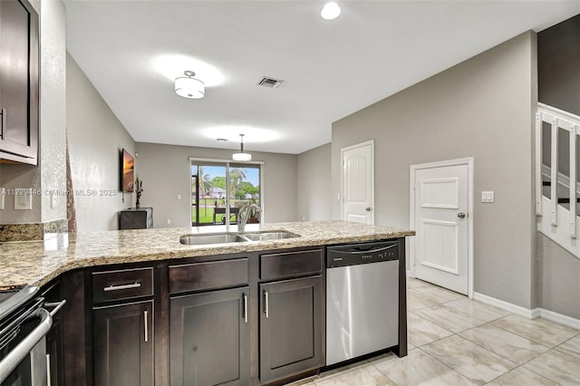 kitchen with kitchen peninsula, appliances with stainless steel finishes, sink, and dark brown cabinets