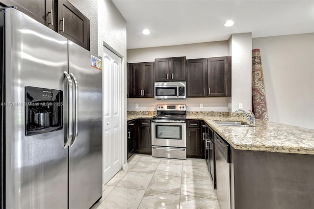 kitchen with sink, kitchen peninsula, stainless steel appliances, and dark brown cabinets