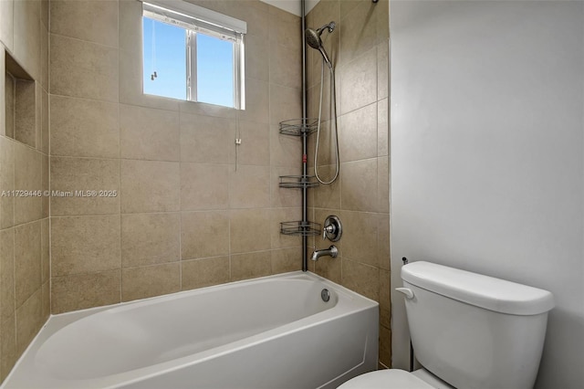 bathroom with toilet and tiled shower / bath combo