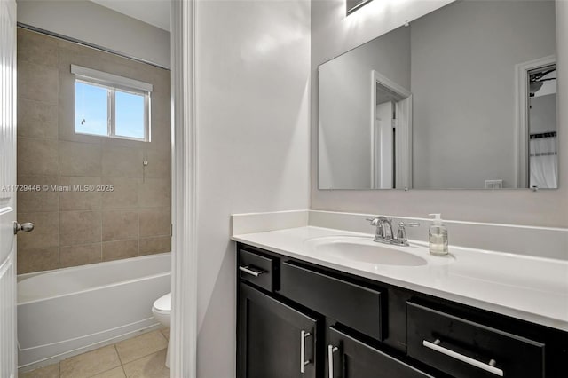 full bathroom featuring toilet, tiled shower / bath, tile patterned floors, and vanity