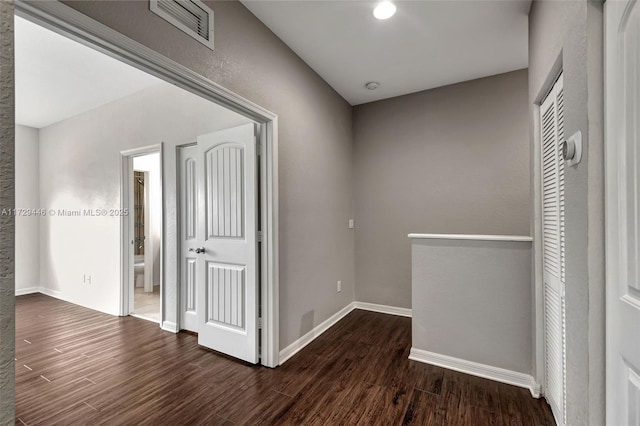 hall with dark wood-type flooring