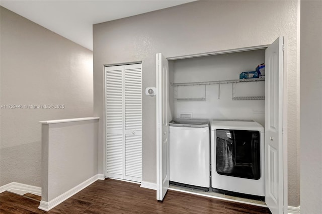 laundry area with separate washer and dryer and dark hardwood / wood-style floors