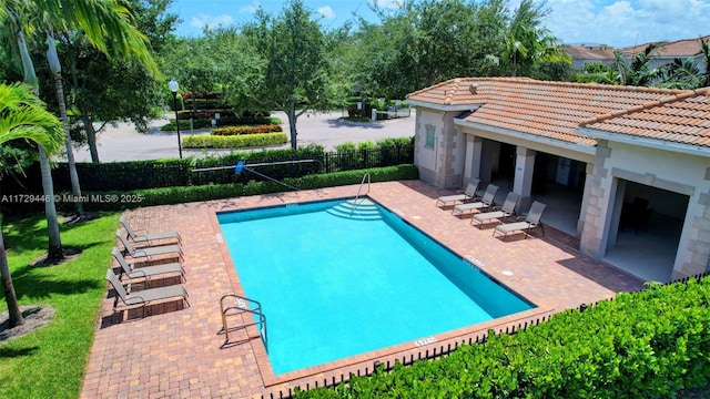 view of swimming pool with a patio area