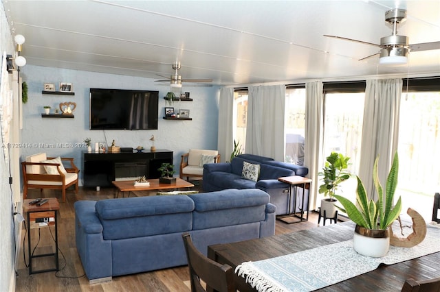 living room with ceiling fan, lofted ceiling, and hardwood / wood-style flooring