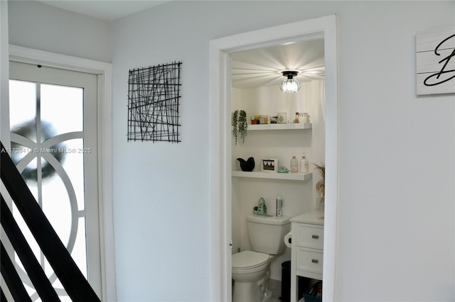 bathroom featuring toilet and vanity