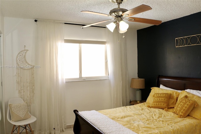 bedroom with ceiling fan and a textured ceiling