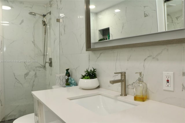 bathroom with toilet, an enclosed shower, and vanity