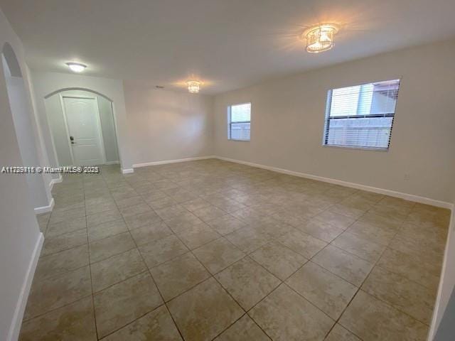 unfurnished room with light tile patterned flooring