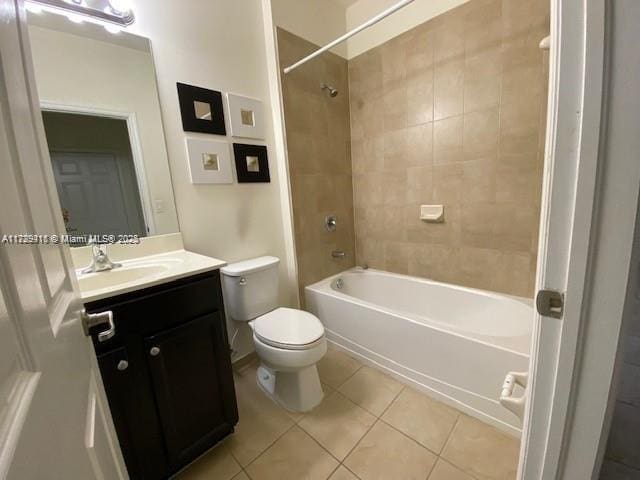 full bathroom featuring tiled shower / bath combo, vanity, toilet, and tile patterned flooring