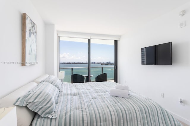 bedroom featuring floor to ceiling windows and access to exterior