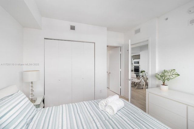 bedroom featuring a closet and light hardwood / wood-style flooring