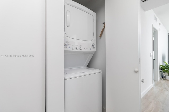 laundry area featuring stacked washer / dryer