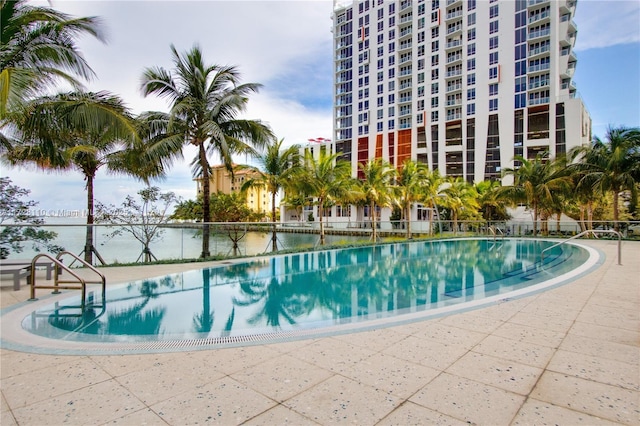 view of swimming pool with a water view