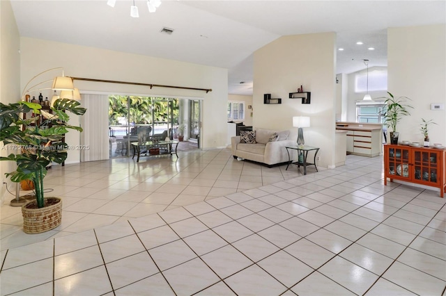 living room with lofted ceiling and light tile patterned floors