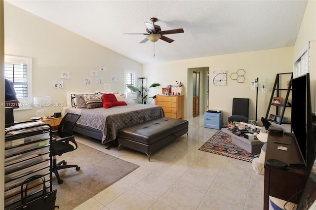 tiled bedroom featuring ceiling fan, a textured ceiling, and vaulted ceiling