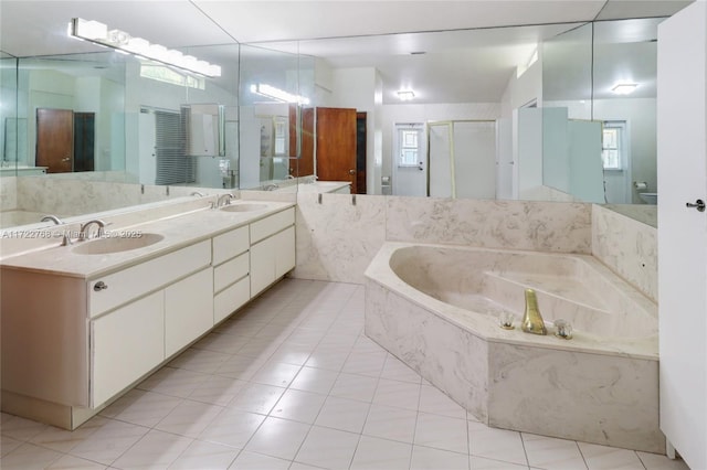 bathroom featuring separate shower and tub, vanity, and tile patterned floors