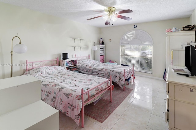 tiled bedroom featuring ceiling fan and a textured ceiling