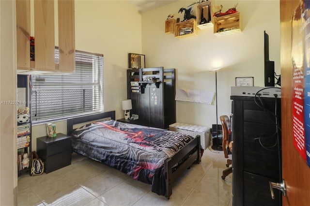 bedroom with light tile patterned flooring and lofted ceiling