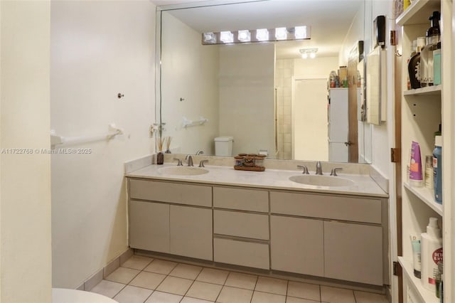 bathroom with toilet, tile patterned floors, and vanity