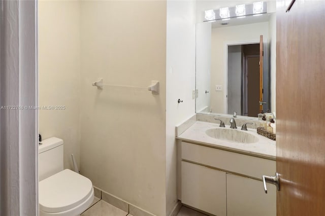 bathroom featuring toilet, tile patterned floors, and vanity