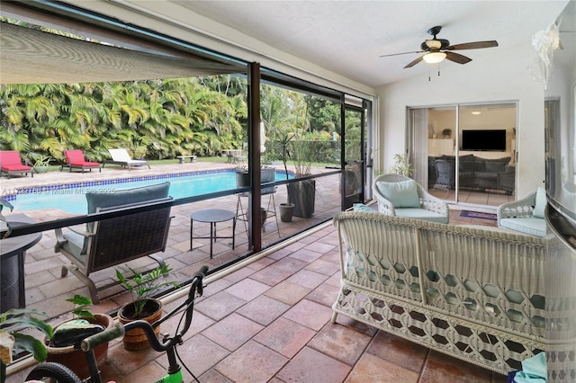 sunroom / solarium featuring ceiling fan and vaulted ceiling