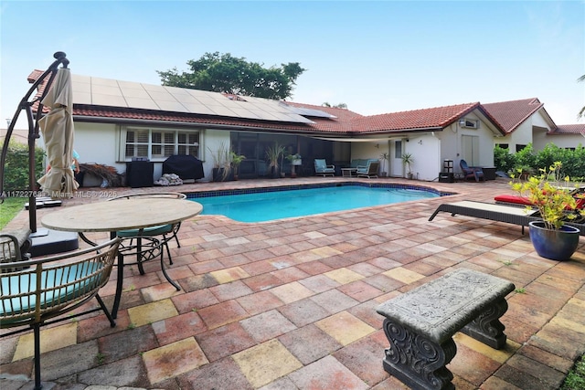 view of swimming pool featuring a patio area and grilling area