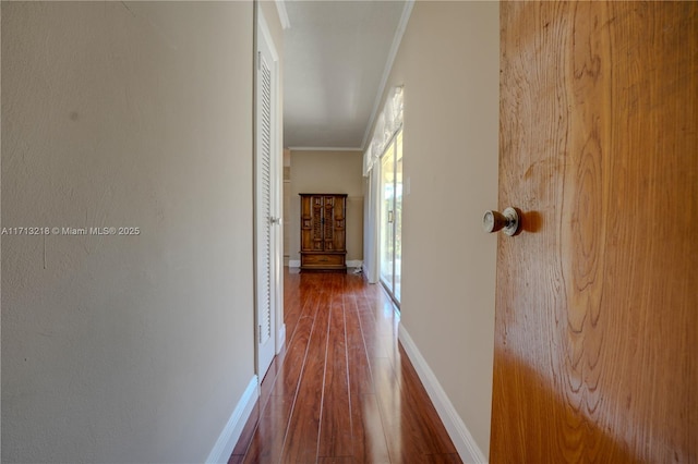 corridor with crown molding and hardwood / wood-style floors