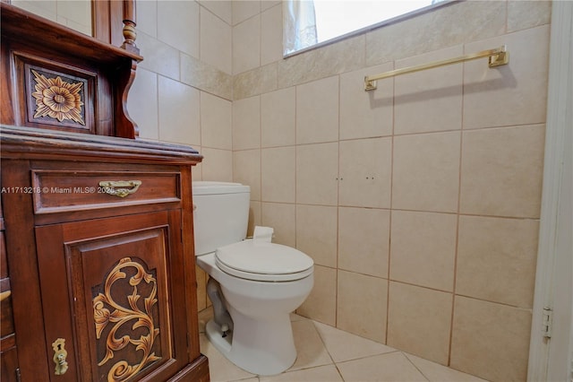 bathroom featuring toilet, tile walls, and tile patterned floors