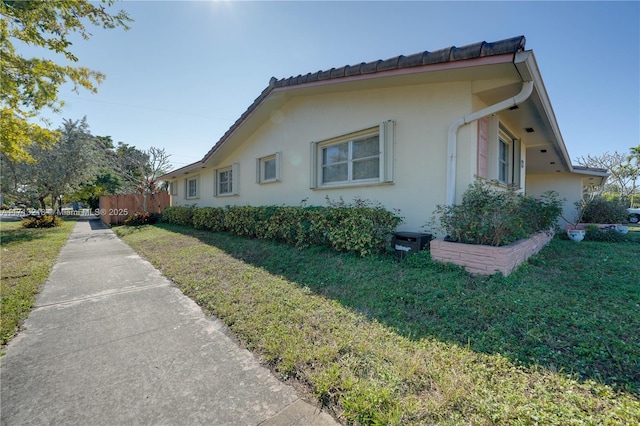 view of side of home featuring a lawn