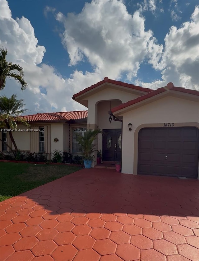 mediterranean / spanish home with a garage