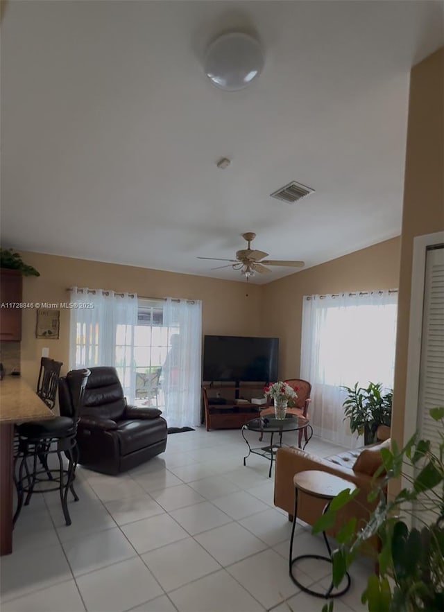 living room featuring ceiling fan and light tile patterned flooring