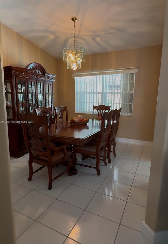 dining area with an inviting chandelier and light tile patterned flooring